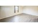 Bedroom features neutral walls, wood-look flooring, and a window with curtains at 6104 Hudson St, Commerce City, CO 80022