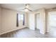 Bedroom features neutral walls, wood-look flooring, a window with curtains, and closet at 6104 Hudson St, Commerce City, CO 80022