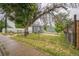 Charming home featuring a detached garage with a basketball hoop and fenced yard, providing a cozy and private outdoor space at 6104 Hudson St, Commerce City, CO 80022