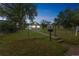The lovely home is surrounded by mature trees and a lush front yard at 6104 Hudson St, Commerce City, CO 80022