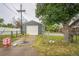 Detached garage with white door and some extra parking space at 6104 Hudson St, Commerce City, CO 80022
