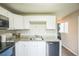 Featuring a stainless steel sink, stainless steel appliances, and white cabinets at 6104 Hudson St, Commerce City, CO 80022