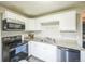 A kitchen featuring white cabinets, and stainless steel appliances at 6104 Hudson St, Commerce City, CO 80022