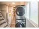 Efficient laundry area featuring a stackable washer and dryer set by a window at 6104 Hudson St, Commerce City, CO 80022