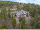A beautiful mountain home, nestled in a forest, with a stone-landscaped yard and large deck at 1055 Divide View Dr, Golden, CO 80403