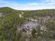 An aerial view showing the property's location amidst lush forests and mountain scenery at 1055 Divide View Dr, Golden, CO 80403