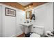 Powder room with unique patterned wallpaper, a pedestal sink, and wood floors at 1055 Divide View Dr, Golden, CO 80403