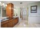 Elegant bathroom with double vanity, wood cabinets, granite counters, and bright neutral color palette at 1055 Divide View Dr, Golden, CO 80403