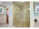 Updated bathroom featuring a glass shower with seat, neutral tile, and wainscoting at 1055 Divide View Dr, Golden, CO 80403