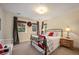 Cozy bedroom with carpet and a bed with red accents and two large windows at 1055 Divide View Dr, Golden, CO 80403