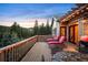 Relaxing deck with outdoor furniture, grill, and pergola providing ambiance and privacy with mountain views at 1055 Divide View Dr, Golden, CO 80403