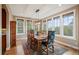 Bright dining room with hardwood floors, mountain views, and a rustic wooden table set for eight at 1055 Divide View Dr, Golden, CO 80403