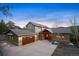 Charming home with a three-car garage, inviting front entrance, and a well-maintained concrete driveway at 1055 Divide View Dr, Golden, CO 80403