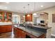 Open kitchen featuring custom cabinetry, granite countertops, and pendant lighting above the island at 1055 Divide View Dr, Golden, CO 80403