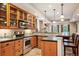 Well-lit kitchen featuring stainless steel appliances, wooden cabinets, and a functional bar area at 1055 Divide View Dr, Golden, CO 80403