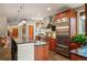 Gourmet kitchen with granite counters, stainless appliances, island with breakfast bar, and wood cabinets at 1055 Divide View Dr, Golden, CO 80403