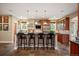 Kitchen features stainless appliances, dark countertops, and island with bar stool seating at 1055 Divide View Dr, Golden, CO 80403