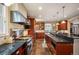 Kitchen features stainless steel appliances, custom cabinets, granite countertops, and an island at 1055 Divide View Dr, Golden, CO 80403