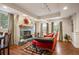 Cozy living room featuring a stone fireplace, hardwood floors, and comfortable seating with great natural light at 1055 Divide View Dr, Golden, CO 80403