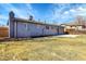 Backyard view with a grassy lawn and a concrete patio with great natural light at 7054 Welch Ct, Arvada, CO 80004