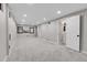 Spacious finished basement with neutral carpet, recessed lighting, and access to a full bathroom at 7054 Welch Ct, Arvada, CO 80004