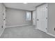 Basement bedroom features neutral carpet, a window for light, and closet space at 7054 Welch Ct, Arvada, CO 80004