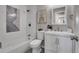 Well-lit bathroom showcasing a shower-tub combo, modern vanity, and elegant tile work at 7054 Welch Ct, Arvada, CO 80004