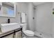 This bathroom includes a vessel sink, stylish vanity, and tiled shower at 7054 Welch Ct, Arvada, CO 80004