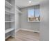 This bedroom features a built-in closet and a window for natural light at 7054 Welch Ct, Arvada, CO 80004