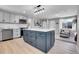 Beautiful kitchen with a large island, stainless steel appliances, and modern lighting fixture at 7054 Welch Ct, Arvada, CO 80004