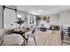 Open-concept living area featuring modern decor, a dining area, and a sunlit living space with luxury vinyl flooring at 7054 Welch Ct, Arvada, CO 80004
