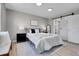 Bedroom features modern decor, large closet with sliding door, and neutral colors at 7054 Welch Ct, Arvada, CO 80004