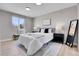 Serene main bedroom with a cozy bed, neutral decor, and ample natural light with luxury vinyl flooring throughout at 7054 Welch Ct, Arvada, CO 80004