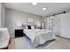 Comfortable main bedroom featuring a king-size bed, a large window, and a closet with luxury vinyl flooring at 7054 Welch Ct, Arvada, CO 80004