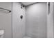 Shower with modern tile, a shower head, and sleek fixtures at 7054 Welch Ct, Arvada, CO 80004