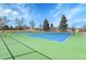 Well-maintained tennis courts offer a recreational space with a bright blue and green surface at 7054 Welch Ct, Arvada, CO 80004