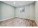 Bedroom with neutral walls and wood-look flooring, offering a calming and versatile space for relaxation at 10819 Mountshire Cir, Highlands Ranch, CO 80126