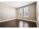 Bright and airy bedroom with gleaming hardwood floors and natural light from two windows at 10819 Mountshire Cir, Highlands Ranch, CO 80126