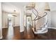 Elegant foyer featuring wood floors, staircase with decorative railing and arched doorways at 10819 Mountshire Cir, Highlands Ranch, CO 80126