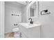 Close up of a clean white bathroom with black hardware and modern fixtures at 264 S Newark Cir, Aurora, CO 80012