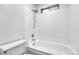Bright bathroom featuring a white bathtub and shower combination at 264 S Newark Cir, Aurora, CO 80012