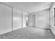 Bright bedroom featuring carpeted floors, a large closet and a window at 264 S Newark Cir, Aurora, CO 80012