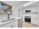 Modern kitchen with white cabinets, stainless steel appliances, and quartz countertops at 264 S Newark Cir, Aurora, CO 80012