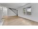 Open living room with light wood floors and stairs at 264 S Newark Cir, Aurora, CO 80012