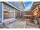 Small, fenced patio with a sliding glass door entrance from the interior of the home at 264 S Newark Cir, Aurora, CO 80012