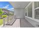 Covered back porch with wood flooring overlooking the yard at 8772 S Sicily Ct, Aurora, CO 80016