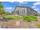 Exterior view of a modern home with a stone and rock landscaping at 8772 S Sicily Ct, Aurora, CO 80016