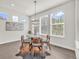 Bright dining area features a modern chandelier and lots of natural light at 8772 S Sicily Ct, Aurora, CO 80016