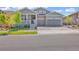 Charming two-story home with a well-manicured lawn and a two-car garage, stone accents, and inviting front porch at 8772 S Sicily Ct, Aurora, CO 80016