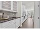 Kitchen featuring stone tile backsplash, stainless appliances, and custom cabinets at 8772 S Sicily Ct, Aurora, CO 80016